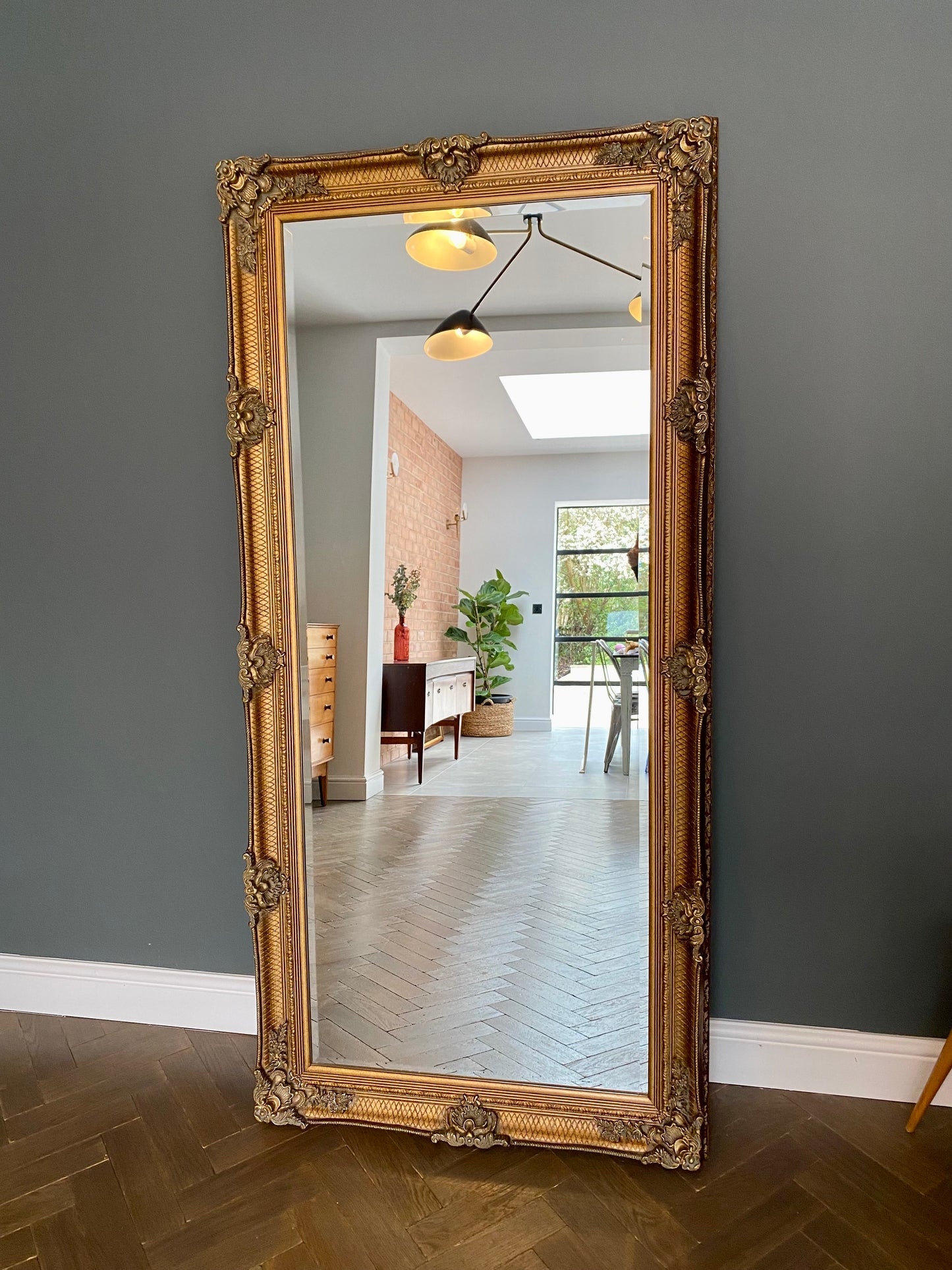Large ornate gold portrait mirror