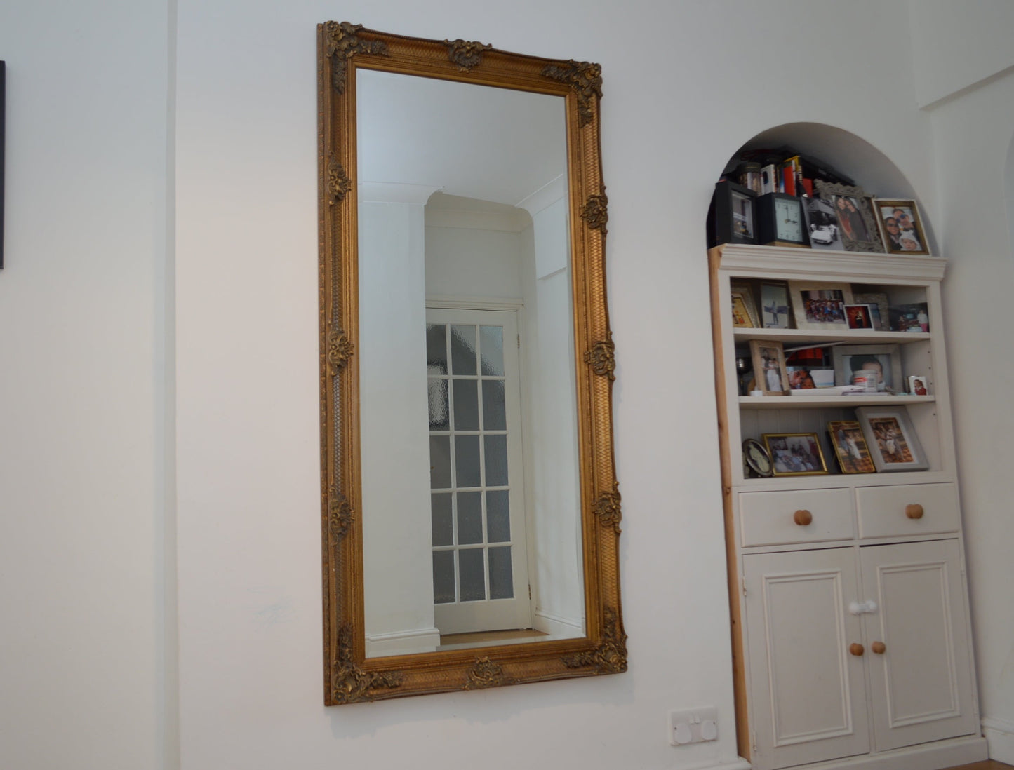 Large ornate gold portrait mirror