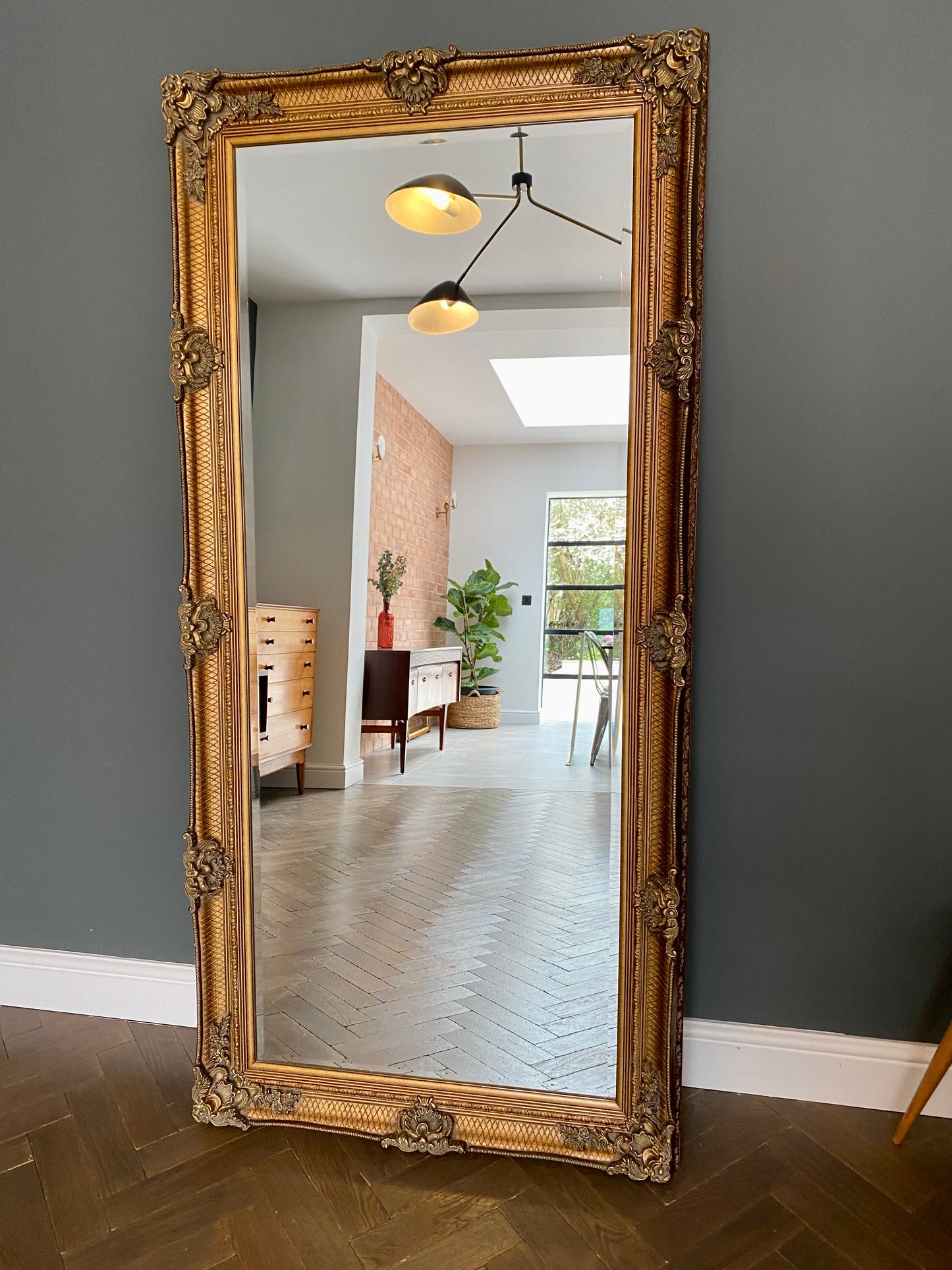 Large ornate gold portrait mirror