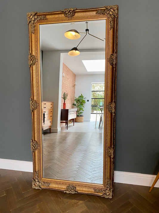 Large ornate gold portrait mirror